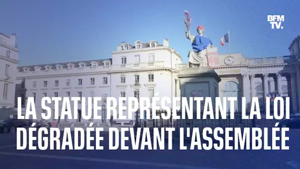 Devant l’Assemblée nationale, la statue représentant la loi  dégradée par l’ONG Attac